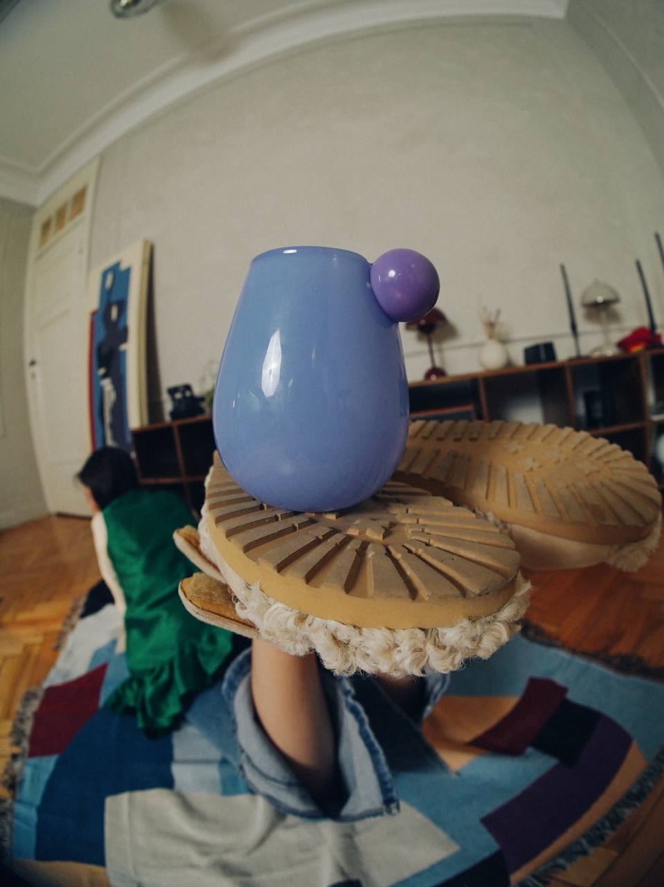 Periwinkle cup balanced on a platform shoe in a stylised interior shot for the décor brand